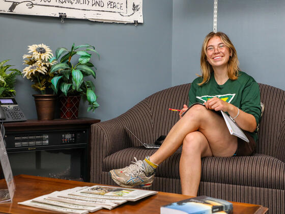 Student sitting in the Writing Center lounge.