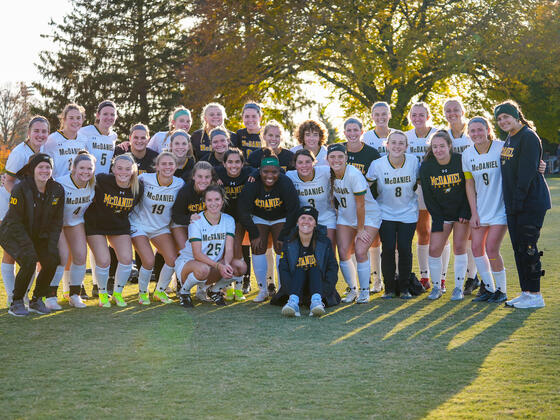 Women's soccer team photo on a grassy field.