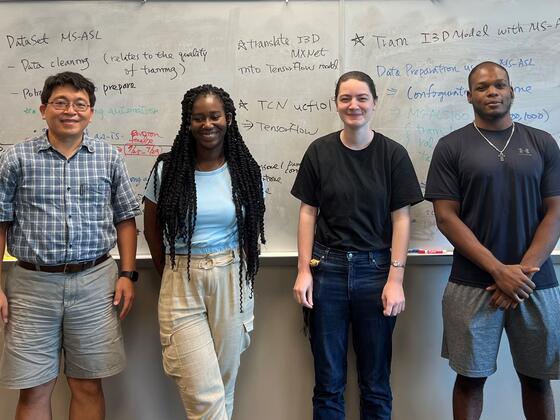 Professor Lin stands with his three summer 2022 research students.