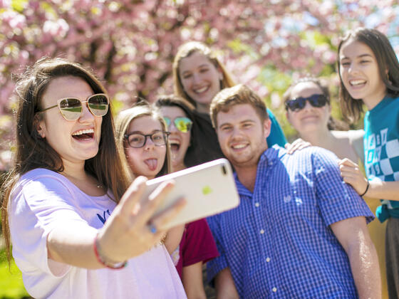 Group of students taking a selfie outdoors.