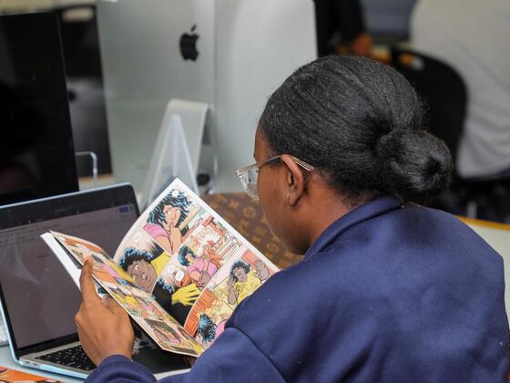 Student Varia Alston reads a comic in the First Year Seminar course titled I am Groot.