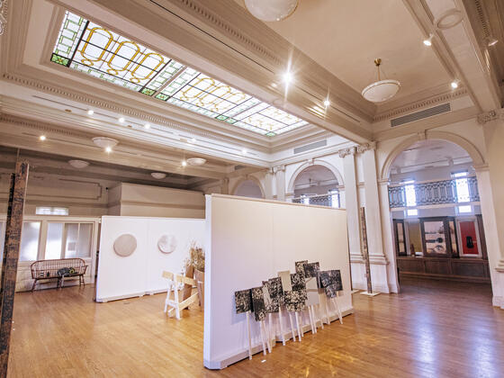 Image of artwork in Rice Gallery beneath a stained glass skylight.