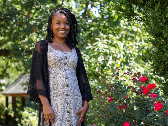 Photo of professor Lyneia Richardson standing outside in a garden.