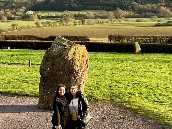 Students standing in front of a rock in Ireland 