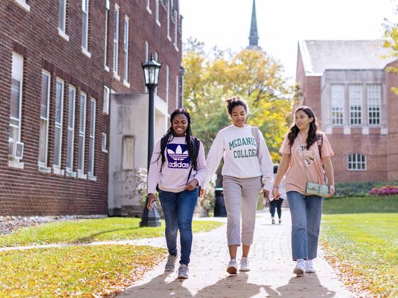 Photo of three students walking together on campus.