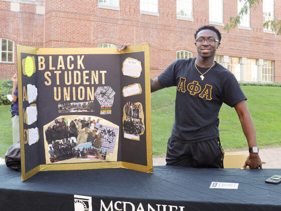 Student with Black Student Union poster 