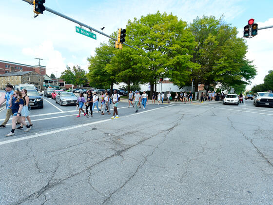 students walk through intersection in downtown westminster