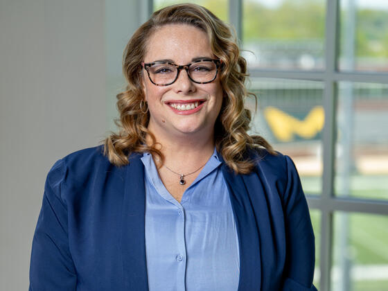 Photo of professor Rebecca Gibson in front of a window.