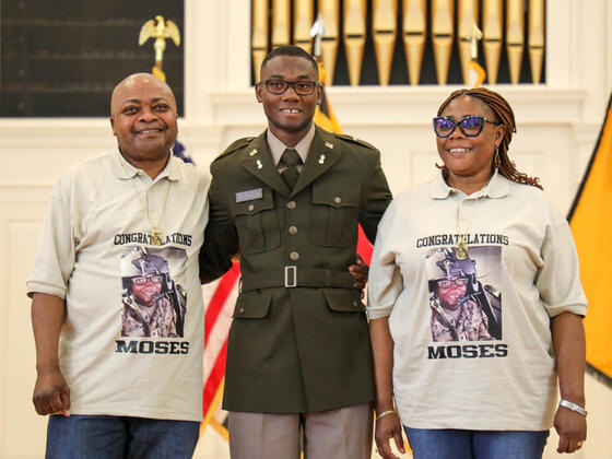 Photo of Moses Jeuronlon with his parents at Commissioning.