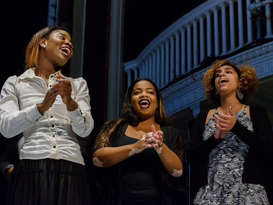 Three women singing in the McDaniel College Gospel Choir.
