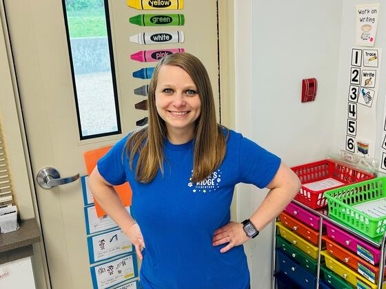 Elizabeth Bittings Seay poses for a picture in front of a door in a classroom