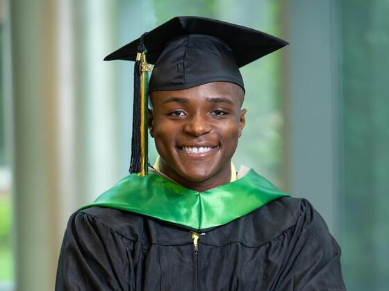 Headshot of Habeeb Baba wearing graduation regalia. 