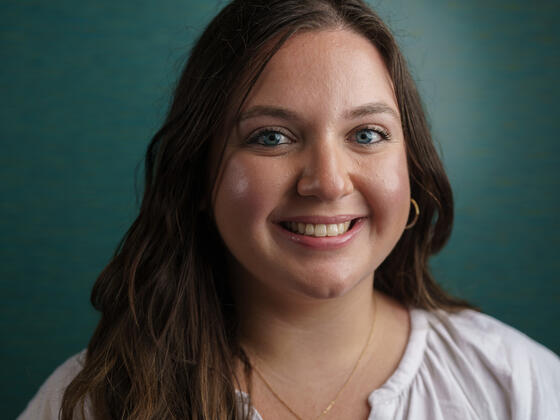 Headshot of Kerriann Ring in a white blouse.