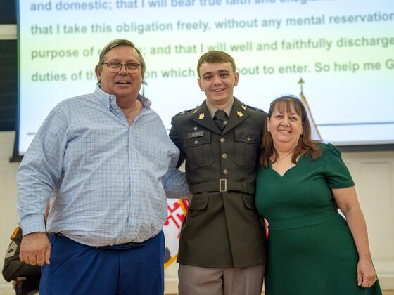 Kevin Aquino, in Army uniform, smiles with his mom and dad at Commissioning.