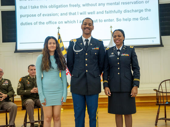 Bellebranche stands in uniform between his wife and sister afer he recieved his pins.