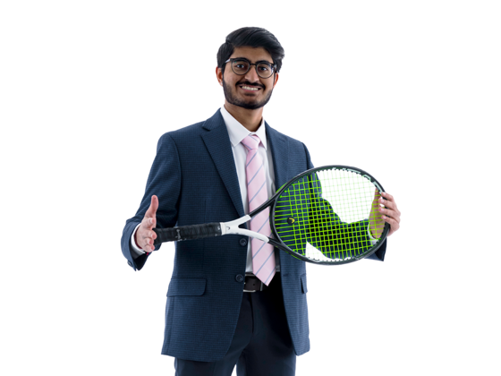 Parth Shah stands waering a blue suit and holding a tennis racket horizontally in front of him.