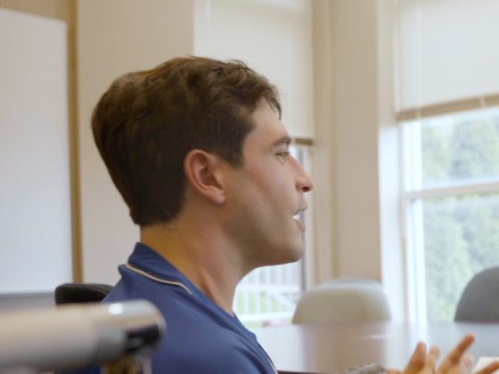 teacher and student sit at a desk