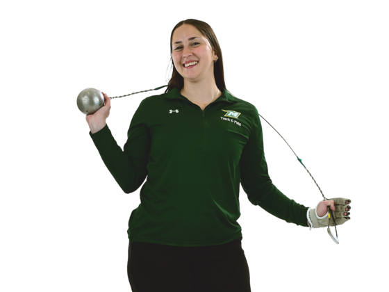A female student in McDaniel athletic gear poses with a throwing weight.