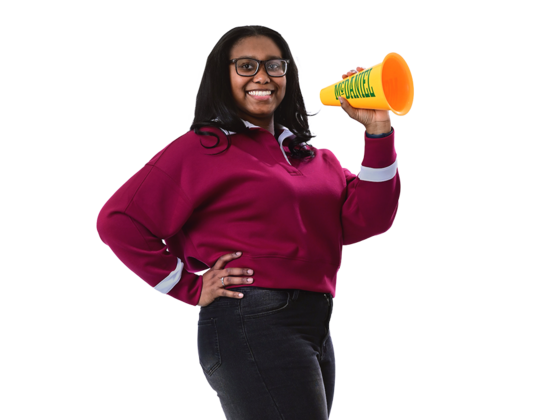 A female student smiles and holds a McDaniel megaphone.