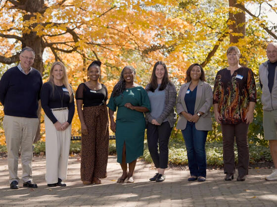 a group of adult students pose outdoors