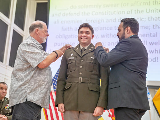 Cainan Schmidt gets pinned by his father and grandfather.