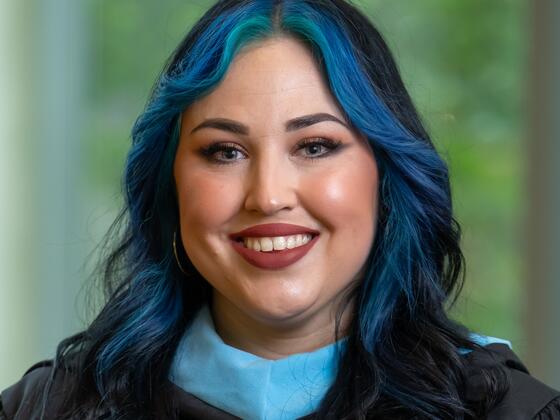 student in graduation regalia
