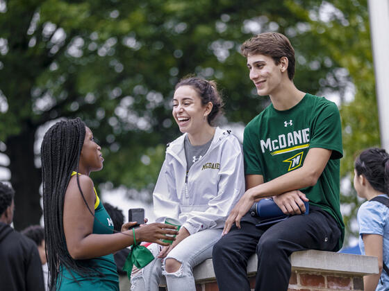 students socializing on campus at McDaniel College athletic event