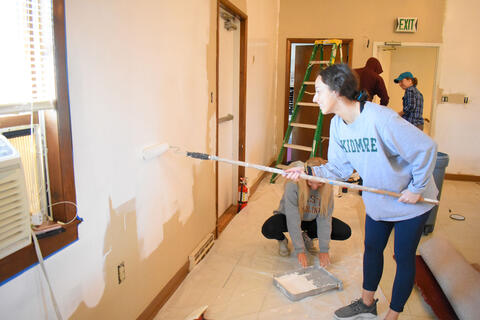 McDaniel College freshmen Abby Doff, left, and Alea Baily help paint a room at Union Street United Methodist Church on Monday.