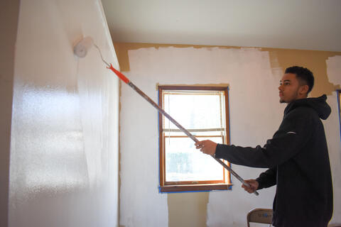 McDaniel College freshman Christopher Swayne paints a multipurpose room at Union Street United Methodist Church on Martin Luther King Jr. Day.