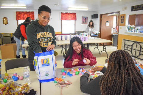 McDaniel College junior Mikayla Braswell assists freshmen Kaeana Aguon and Cammie Beazer with sorting and stuffing plastic eggs for the City of Westminster on Martin Luther King Jr. Day.