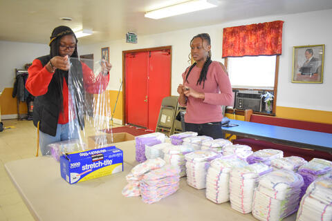 McDaniel College freshmen Frieda Anong, left, and Maya Williams helped bundle diapers for CarrollBaby on Monday, Jan. 20.