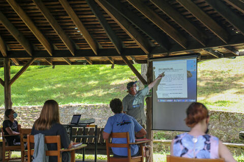 Jonathan Slade, professor of Communication & Cinema, teaches outside in Harvey Stone Pavilion.