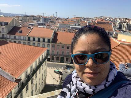 Alumni Jessica Watson in front of building skyline in Lisbon, Portugal.