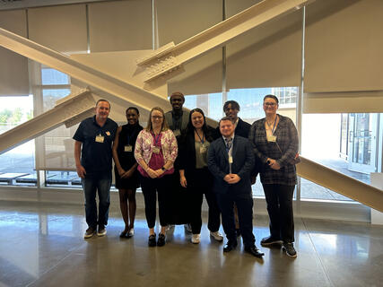 Student presenters and faculty pose for a photo. Pictured in the photo from Left to right are Associate Professor Peter Craig, Makela Brown, Assistant Professor Stephanie Homan, Kramoh Mansalay, Ashley Reyes, Matt Denny, Khaleel Lee, and Lauren Logue.
