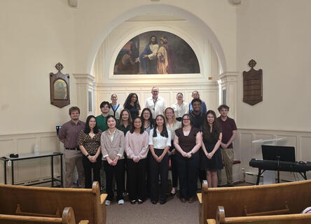 Students standing in a group smiling during their induction
