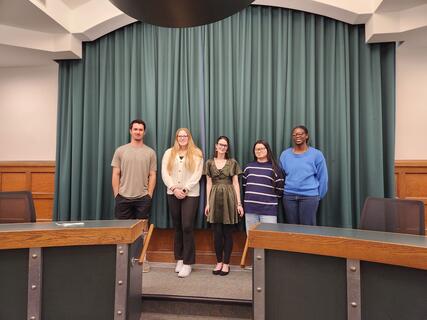 Students standing in a group smiling during their induction