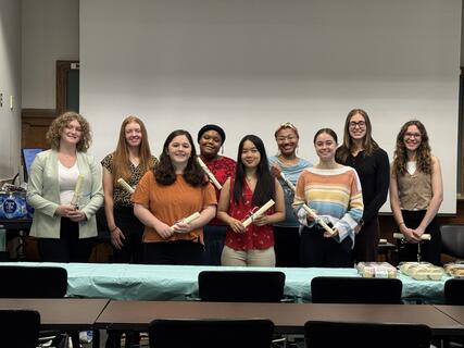 Students standing in a group smiling during their induction