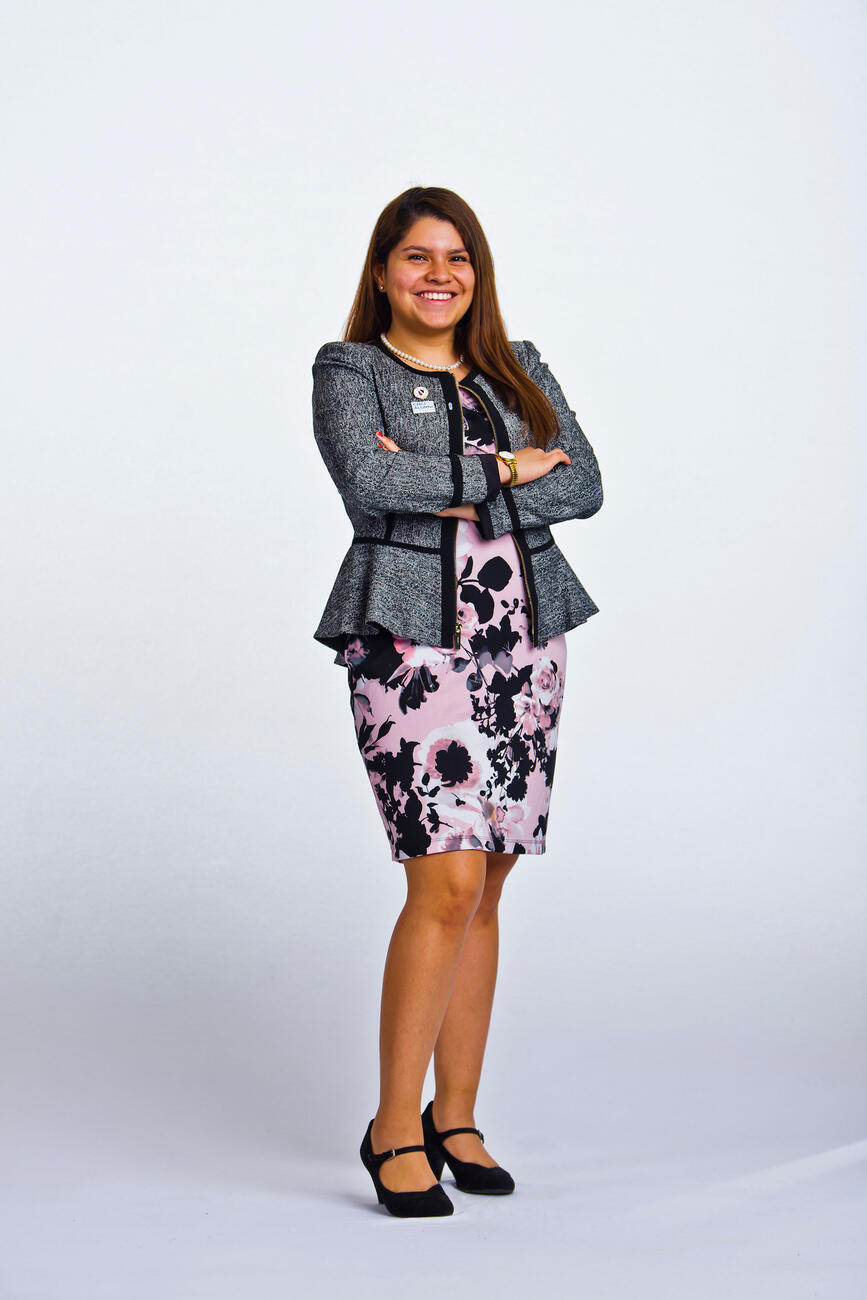 Jasmin Chavez standing in front of a white background.