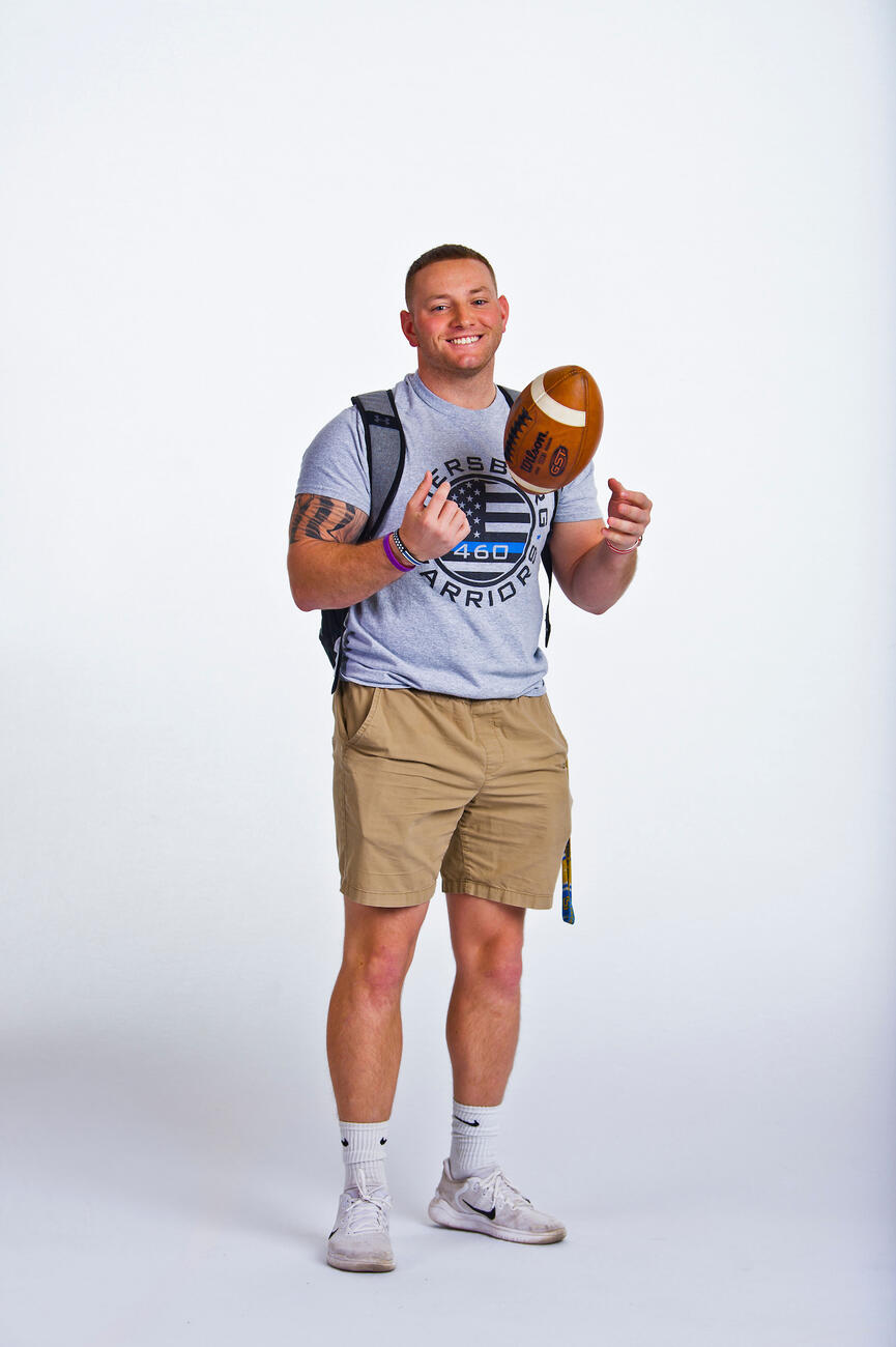 Rodney Fisher tossing a football up in the air.