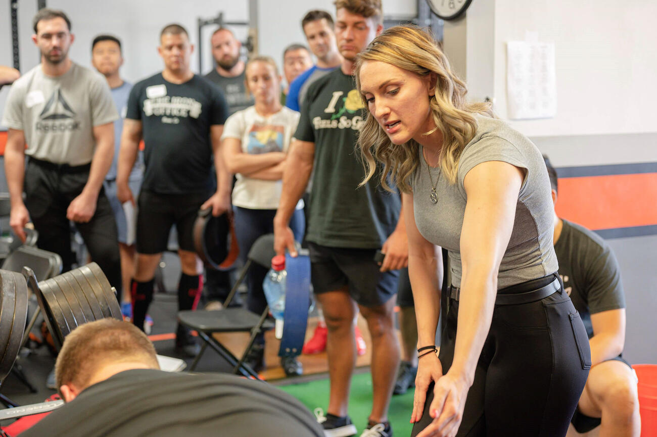 Nicole Rutherford ’16 teaches the deadlift as a platform coach at the L.A. Starting Strength seminar.