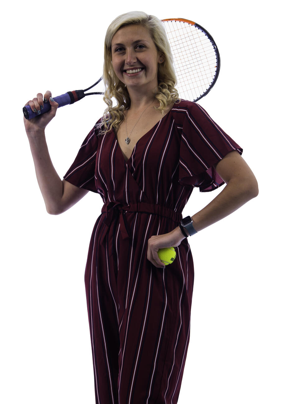 Kassidee Wright poses with a tennis ball in one hand and her tennis racket on her shoulder.