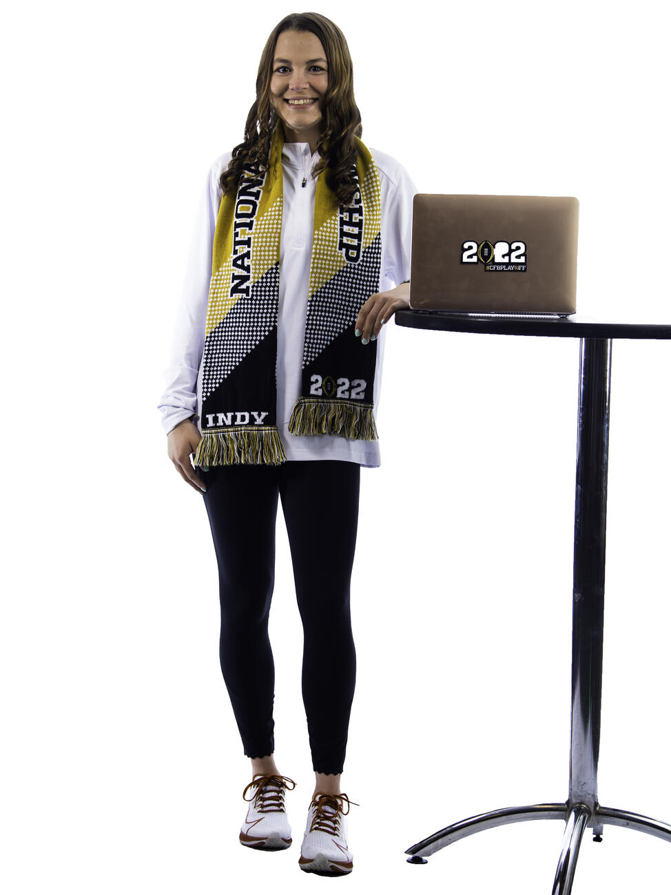 Kaylen Buschhorn poses by a table with a laptop.