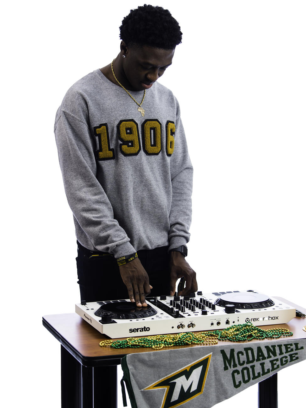 Kekuta Bah poses with a DJ board on a table.