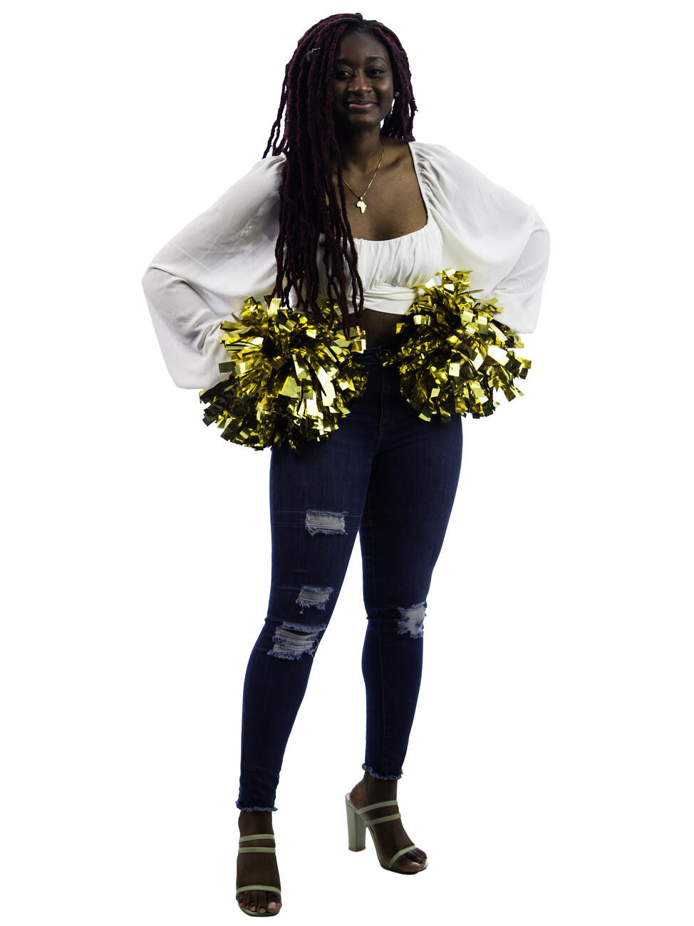 Tracey Ackah holding two gold pompoms with her hands on her hips.