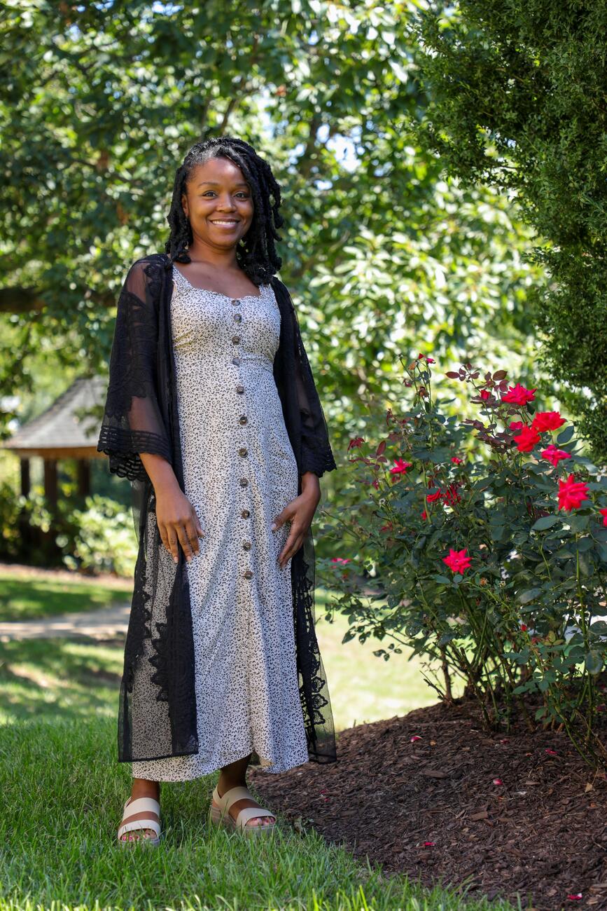 Photo of professor Lyneia Richardson standing outside in a garden.