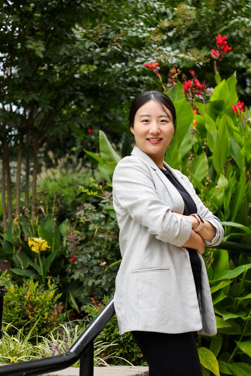 Photo of professor Xuejing Duan standing outdoors on campus.