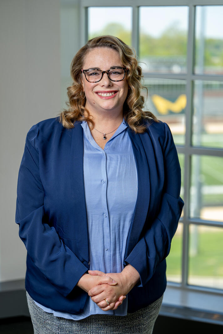 Photo of professor Rebecca Gibson in front of a window.