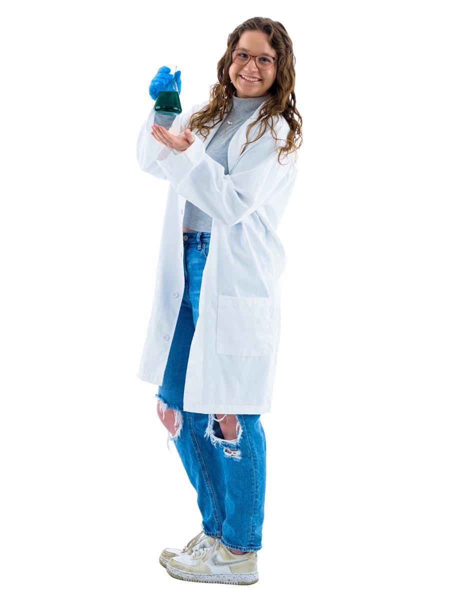 Mackenzie McCarter wearing a white lab coat holding a beaker