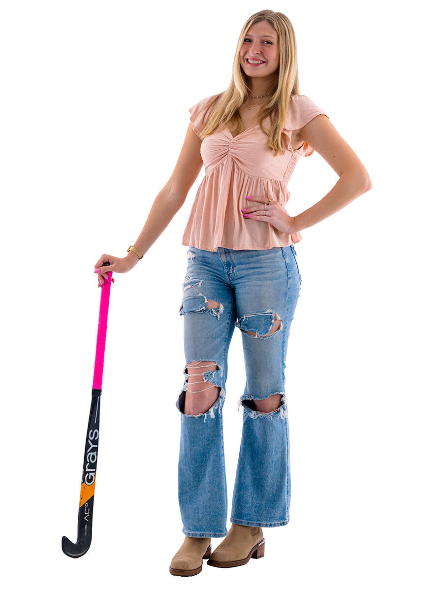 Madge Myers holding field hockey stick