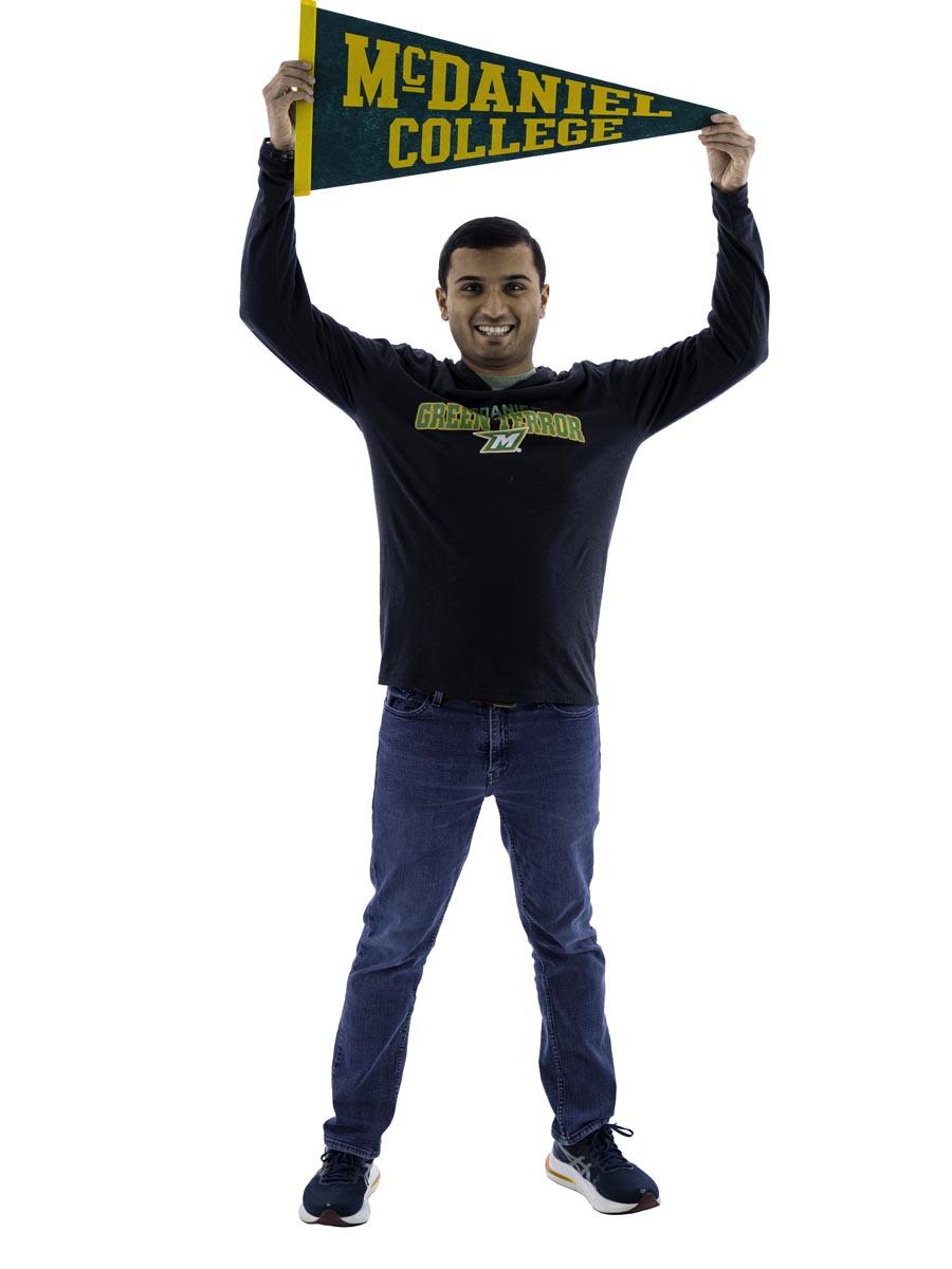 Nikhil Niyogi holding up a McDaniel College pennant